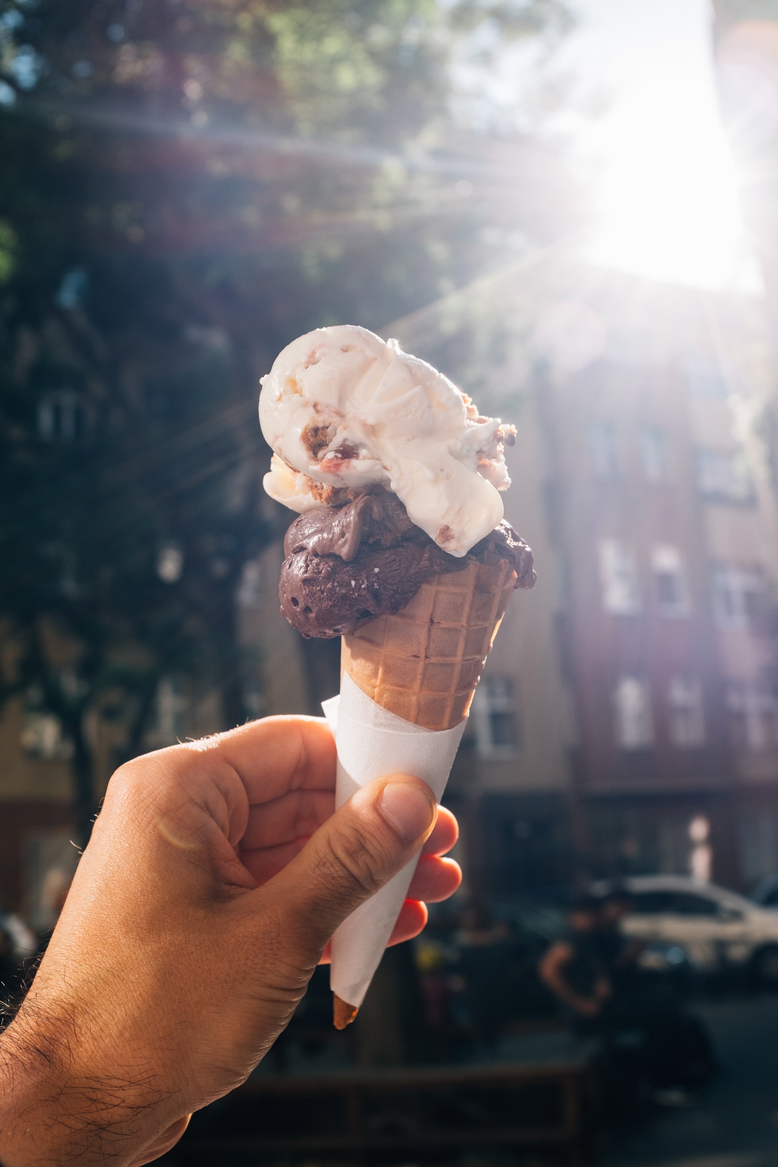 hand-holds-up-a-two-scoop-ice-cream-cone